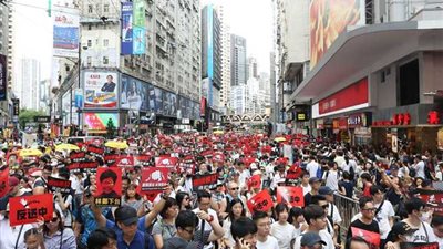 أكثر من 1000 شخص يتجمعون في مسيرة بهونج كونج الغارقة تحت المطر